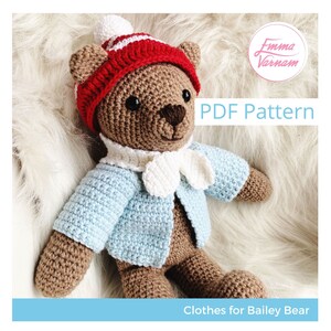 May include: A crochet pattern for a brown bear wearing a blue sweater, white scarf, and red and white striped hat. The pattern is titled "Clothes for Bailey Bear" and is available as a PDF download.