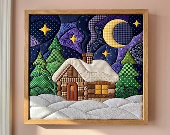 May include: A framed fabric wall art piece depicting a winter cabin scene. The cabin features brown log-style fabric, a white snow-covered roof, and a chimney. It is surrounded by green patterned pine trees, a dark blue night sky, and a yellow crescent moon.