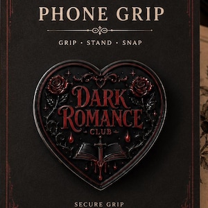 May include: A heart-shaped phone grip on a black display card with the text PHONE GRIP, GRIP STAND SNAP, DARK ROMANCE CLUB, and SECURE GRIP FOR YOUR PHONE. The grip features a dark design with red roses, a book, and a sword in the center.