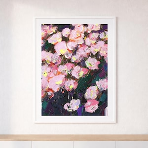 May include: A framed floral painting with a white border. The artwork features a cluster of pink flowers with yellow centers against a dark green and purple background. The painting has visible brushstrokes.