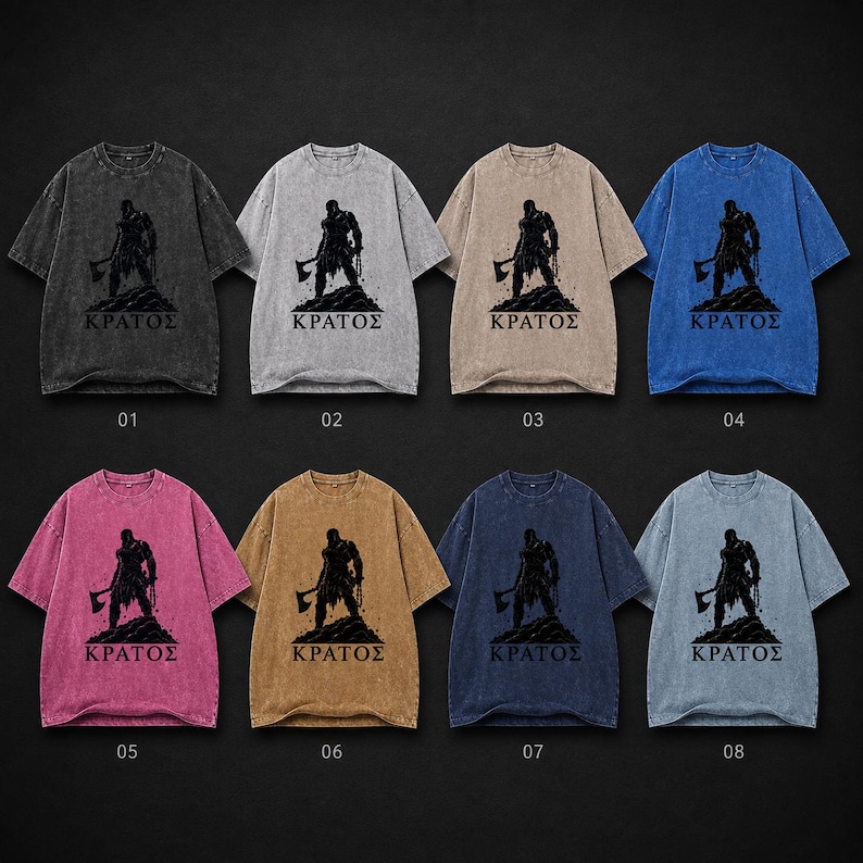 May include: Eight short-sleeve t-shirts in various acid-wash colors, including black, gray, tan, blue, pink, and brown. Each shirt features a black graphic print of a warrior holding an axe standing on a rocky mound with the Greek text &Kappa;&Rho;&Alpha;&Tau;&Omicron;&Sigma;.