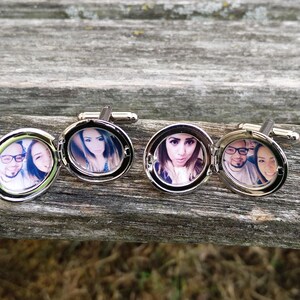 May include: Silver cufflinks with a hinged locket design. Each locket features a different photo of a couple.