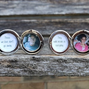 May include: Two silver locket style photo frames with a hinged lid. The locket on the left has a photo of an older man and the text "Those we love don't go away". The locket on the right has a photo of a woman and the text "They walk beside us everyday".