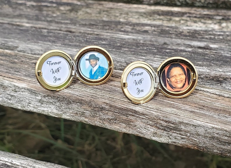 May include: Two gold locket necklaces with a photo of a person inside. The locket is open and the inscription reads "Forever With You".