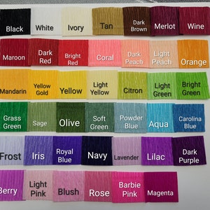 May include: A color chart of 36 different colors of crepe paper. The colors are arranged in rows and columns. The colors include black, white, ivory, tan, dark brown, merlot, wine, maroon, dark red, bright red, coral, dark peach, light peach, orange, mandarin, yellow gold, yellow, light yellow, citron, light green, bright green, grass green, sage, olive, soft green, powder blue, aqua, carolina blue, frost, iris, royal blue, navy, lavender, lilac, dark purple, berry, light pink, blush, rose, barbie pink, and magenta.