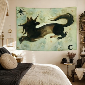 May include: A rectangular wall tapestry featuring a watercolour illustration of a black unicorn-like creature leaping across a pale green background filled with gold and white stars, a sun, and a crescent moon in a celestial night sky theme.