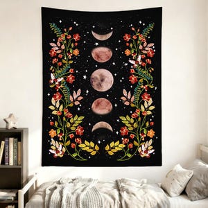 May include: A rectangular wall tapestry featuring a black background with a vertical sequence of five moon phases in the center. Two symmetrical floral vines with red flowers, green leaves, and white moths frame the lunar cycle on both sides.