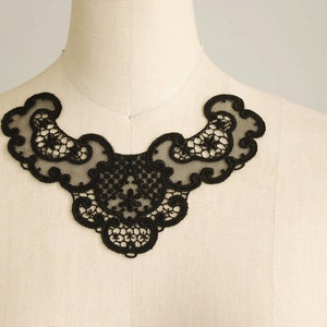 May include: Black lace trim with a delicate floral pattern. This trim is perfect for adding a touch of elegance to any garment.