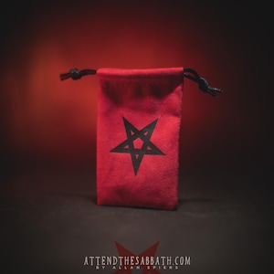 May include: A red velvet pouch with a black pentagram design. The pouch has a drawstring closure and is made of soft, plush fabric.