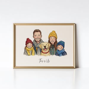 May include: A framed digital illustration of a family of four and a golden retriever dog. The group wears winter hats and scarves. The text "This is Us" is written in black cursive script below the figures. The frame is a metallic gold color.