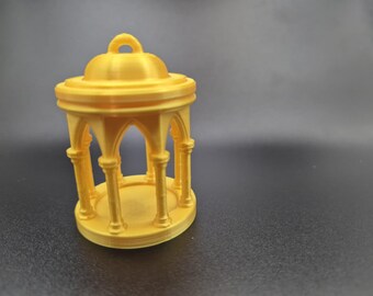 May include: A 3D-printed yellow miniature gazebo with arched openings and a domed roof. The small structure has a circular base and is designed with vertical pillars. The gazebo is a decorative item.