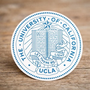 May include: A round sticker featuring the UCLA seal in blue and white. The seal includes text that reads "The University of California" and "Let There Be Light" around an open book and star.
