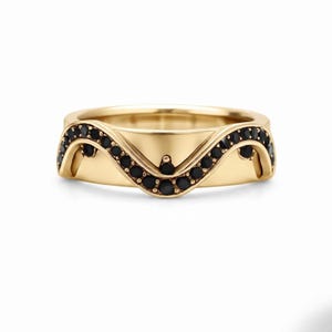 May include: A gold band ring featuring a wavy, contoured design along the top edge. The ring is set with a continuous row of small, round, black gemstones that follow the undulating shape of the metal, creating a distinct, layered appearance.
