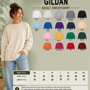 a woman standing in front of a wall with a selection of colorful adult sweatshirts displayed on it.