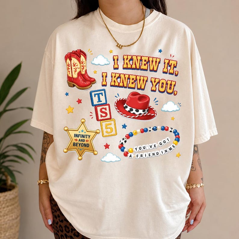 A person wearing a white t-shirt with various cartoon-style icons and text printed on it.