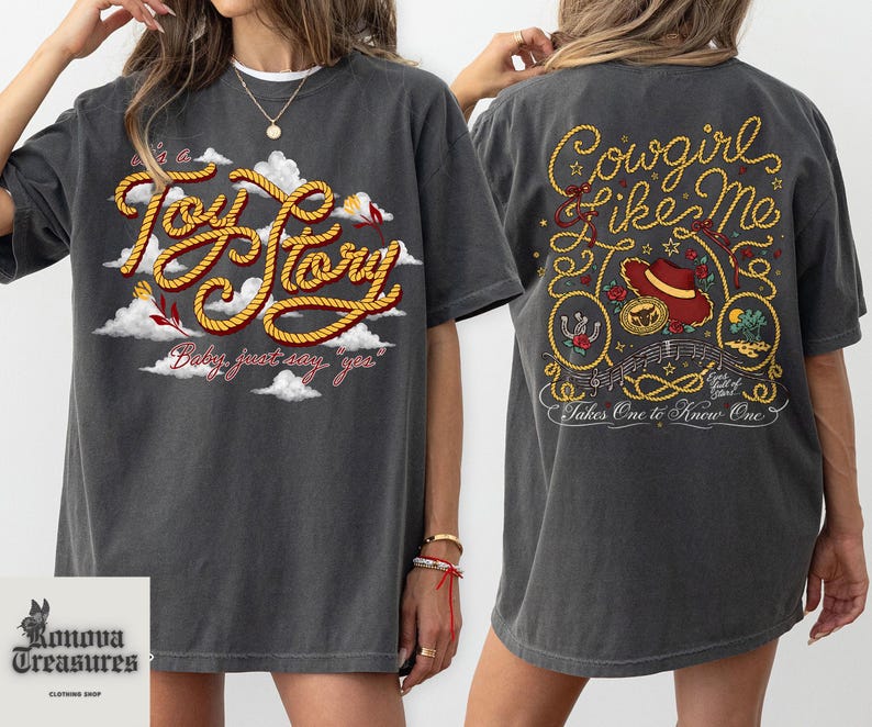 a woman wearing a gray t-shirt with a graphic design on the front and back.
