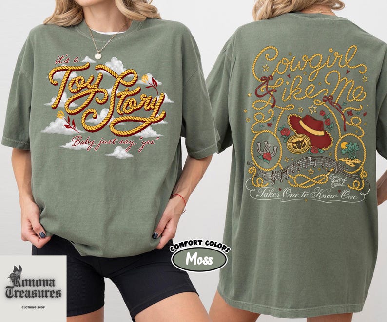 a woman wearing a green t-shirt with a graphic design on the front and back.