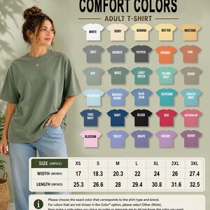 a woman wearing a green t-shirt, standing next to a wall with a list of different colored t-shirts displayed on it.