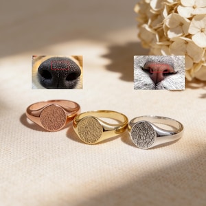 Op de afbeelding: Een set van drie keramische mokken met een gespikkelde, matte afwerking. De mokken zijn in crème, lichtgrijs en donkergrijs. Elke mok heeft een eenvoudig, minimalistisch ontwerp.