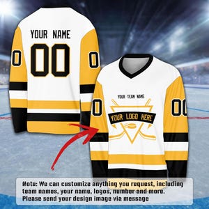 a white and yellow hockey jersey with the text "YOUR NAME" and "YOUR TEAM NAME" printed on it. The jersey also has a logo and a number "00" on the sleeves.
