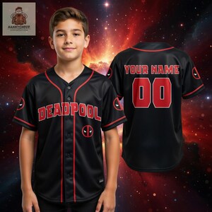 A young boy wearing a black baseball jersey with the word "Deadpool" printed on it, standing in front of a red and orange cosmic background.