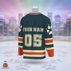 A hockey jersey with the name "YOUR NAME" and the number "05" printed on it, along with paw prints on the sleeves.