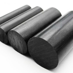 May include: Four black cylindrical rods of varying diameters are arranged diagonally against a white background. The rods have a smooth, matte finish and are cut at a 90-degree angle on the ends. The rods are made of a solid material.