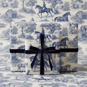 Luxury equestrian toile wrapping paper featuring a classic horse and rider countryside illustration in soft blue and ivory tones, inspired by French country and English heritage aesthetics. Elegant gift wrap for refined presents, birthdays, weddings, anniversaries and timeless occasions. Sophisticated old money style wrapping paper for horse lovers, country homes and luxury gift presentation.