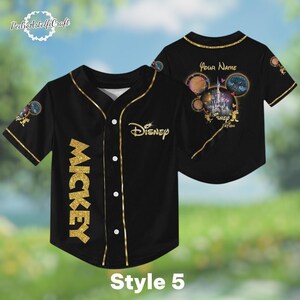 A black baseball jersey with gold accents, featuring the Disney logo and Mickey Mouse imagery. The jersey has a personalized name on the back and appears to be a style 5.