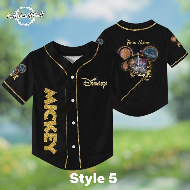 A black baseball jersey with gold accents, featuring the Disney logo and Mickey Mouse imagery. The jersey has a personalized name on the back and appears to be a style 5.