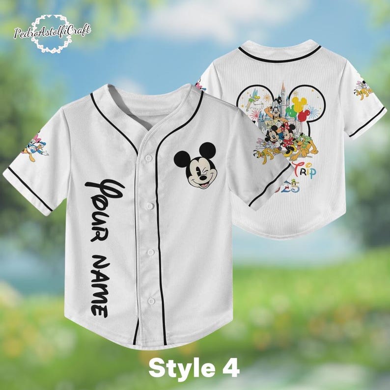 A white baseball jersey with Mickey Mouse and Disney characters printed on it, along with a personalized name tag.