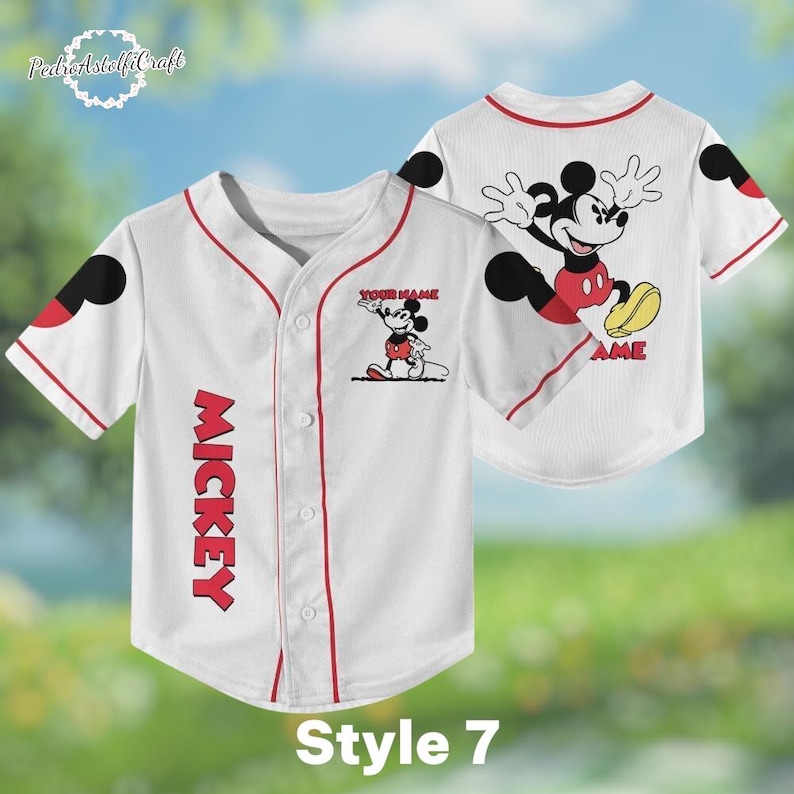 A white baseball jersey with a Mickey Mouse design on the front and back, featuring the word "MICKEY" in red letters.
