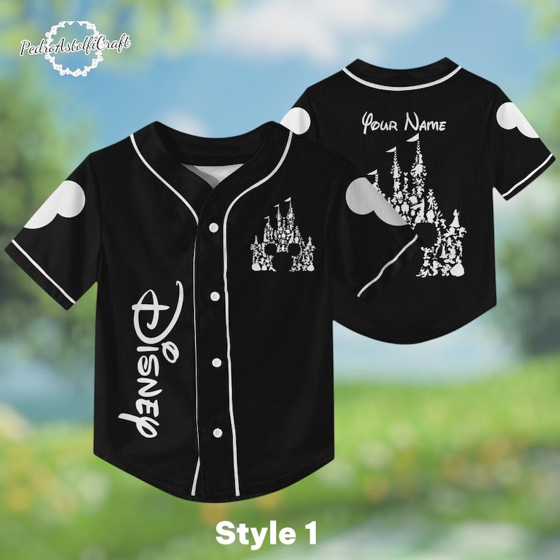 A black baseball jersey with a Disney castle design on the front and back, featuring a personalized name on the back.