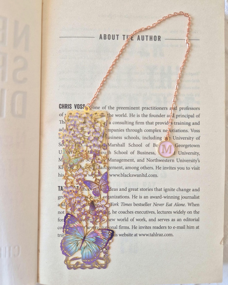 Set of four custom-initial gold-tone metal bookmarks with butterfly and floral filigree, personalized, in blue packaging.