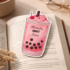 Funny bookmark for book lovers pink boba design romance reader gift on open book
