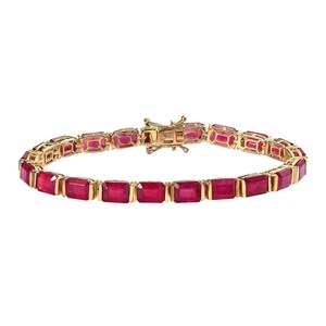 May include: A gold bracelet with rectangular, vivid red gemstones. Each gemstone is set in a gold frame, linked together. The bracelet has a secure clasp. The gemstones are approximately 1 cm in length.