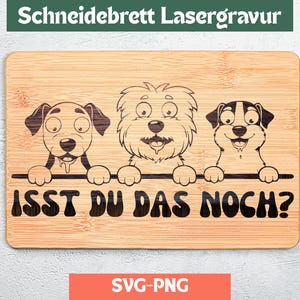May include: A rectangular bamboo cutting board with a laser-engraved design of three cartoon dogs. The text "ISST DU DAS NOCH?" is below the dogs. The top of the board has the text "Schneidebrett Lasergravur".