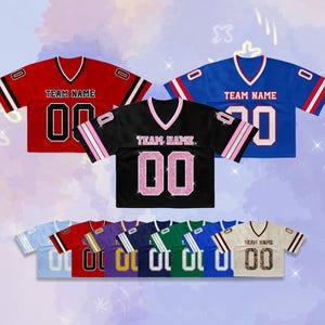 May include: A collection of short-sleeved V-neck jerseys in various colours including red, blue, black, light blue, purple, navy, green, and cream. Each jersey features the text TEAM NAME and the number 00 on the front, with matching sleeve stripes.