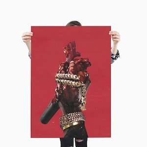 May include: A red poster featuring a stylized illustration of a hand holding a heart, both covered in a dark, viscous substance. The hand is adorned with gold chains and a bracelet. The background is a solid red.
