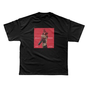 May include: Black t-shirt featuring a red square graphic with the words "BEAST MODE" and "JAYTOVER". The graphic depicts a figure adorned with gold jewelry. The text "FUTURE" is below the graphic.