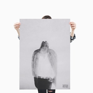 May include: Monochrome poster featuring a blurred image of a person in a jacket and shirt. The poster has a Parental Advisory warning in the bottom right corner. The image is held by a person.