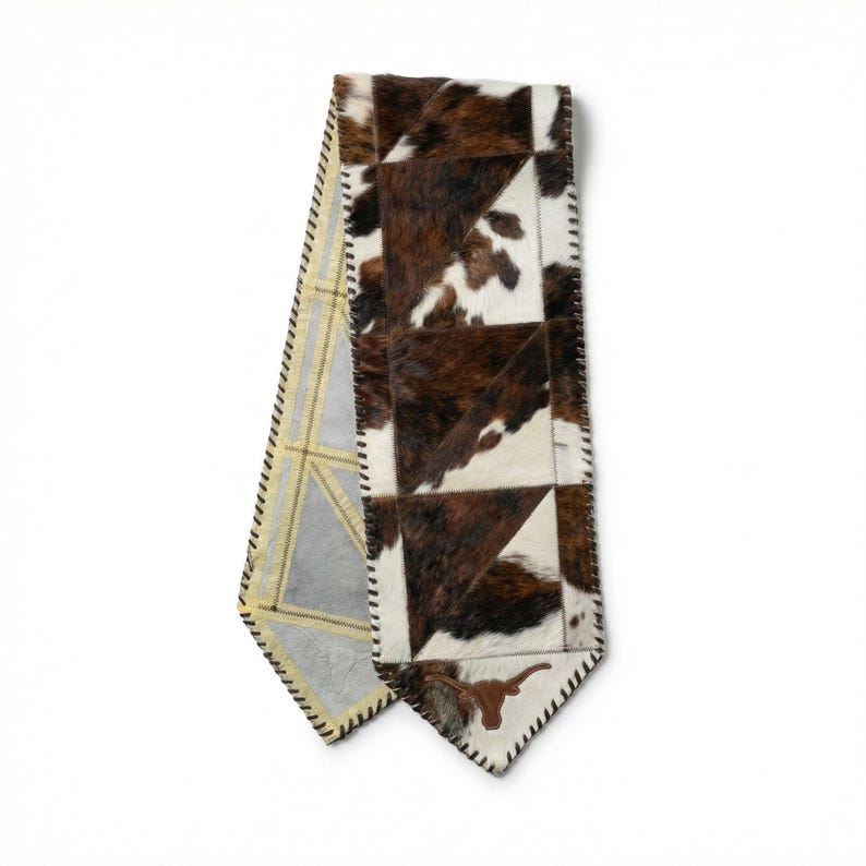 Handmade cowhide table runner with tricolor patchwork leather, longhorn ends, hair on hide panels, western rustic decor, farmhouse dining table accent, leather lace edges, natural cowhide texture