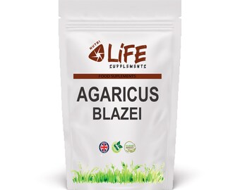 May include: A white pouch of Nutri Life Supplements Agaricus Blazei. The pouch has a brown band with the words "FOOD SUPPLEMENTS" and the brand logo. The text "AGARICUS BLAZEI" is printed in large, bold letters. The bottom of the pouch has green grass.