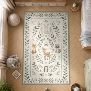 a large rug with a forest theme, including illustrations of animals such as a deer, fox, raccoon, and hedgehog, surrounded by green leaves and flowers. The rug is placed on a wooden floor, and there are other decorative items like a stuffed animal, a basket, and a plant in the room.