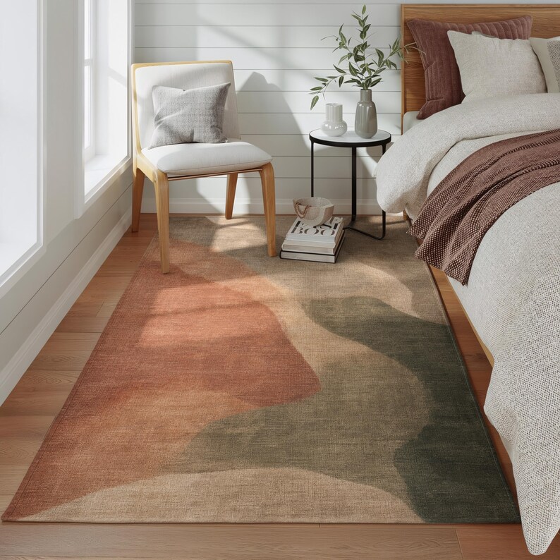 a cozy bedroom with a large bed, a wooden chair, and a colorful rug on the floor.