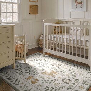 A cozy nursery with a white crib, a dresser, and a rug featuring a forest-themed design.