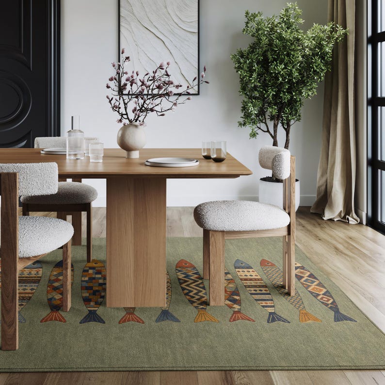 a modern dining room with a wooden table, white chairs, and a decorative rug featuring fish patterns. The room has a minimalist and clean design, with a large window providing natural light.