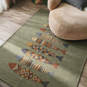 a rug with a fish design on it, placed on a wooden floor next to a beige armchair.