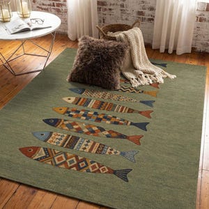 a cozy living room with a rug featuring a fish design, a round table, and a basket of blankets.