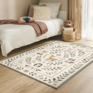 a cozy bedroom scene with a bed, a stuffed teddy bear, and a rug featuring a forest-themed design.